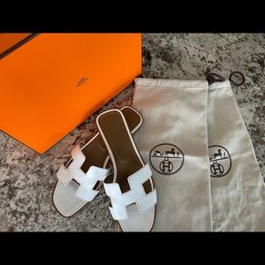 Hermès Oran white sandals.